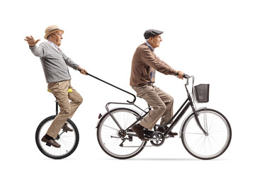 Poster - Elderly man riding a bicycle and pulling another man with a tricycle