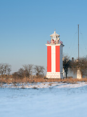 Wall Mural - portrait view to lighthouse under blue sky with copy space and in sun light