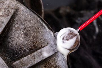 Removing a seized and rusty screw with a chemical agent. Minor repair work on the internal combustion engine.