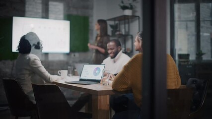 Aufkleber - Project Manager Makes a Presentation for a Young Diverse Creative Team in Meeting Room in an Agency. Colleagues Sit Behind Conference Table and Discuss Business Development, Sales Analysis and Design.