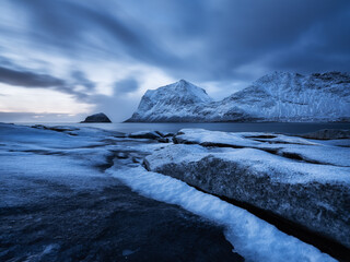 Wall Mural - landscape with long exposure shot. mountains, beach and clouds. haukland beach, lofoten islands, nor