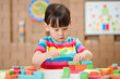 © M-image - young girl playing creative toy blocks for homeschooling