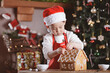 © M-image - young girl making gingerbread house at home