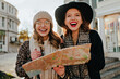 © Look! - Emotional woman in black hat holding city map and laughing. Carefree girls enjoying europe trip in autumn.