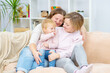 © Ermolaeva Olga - Happy daughter and smiling gay mothers in family home. Gay lesbian couple at home. Lesbian couple concept