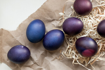 Wall Mural - Painted blue and purple Easter eggs on a textured background. Easter eggs on a plate.