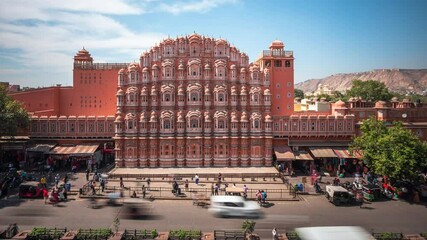 Wall Mural - Daytime time lapse view of historical landmark Hawa Mahal aka Palace of the Winds located in the Pink City of Jaipur in Rajasthan, India.