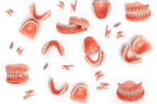 Set Of Dentures On A White Background. Full Removable Plastic Denture Of The Jaws. Isolate On White Background Acrylic Prosthesis Of Human Jaws. Upper And Lower Jaws With Fake Teeth. Jaw In All Angles