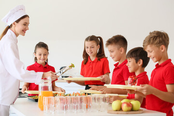 Wall Mural - Pupils receiving lunch in school canteen