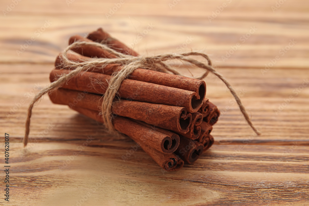 Cinnamon sticks on wooden background