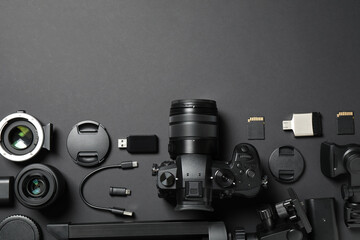 Wall Mural - flat lay composition with camera and video production equipment on black background. space for text
