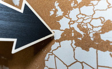 Giant black arrow with copy space pointing to Spain on a nice cork map.