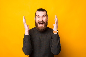 Wall Mural - Photo of amazed man with beard making surprised gesture.