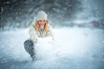 Wall Mural - Happy girl playing with snow outdoor