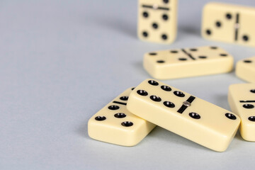 A game of dominoes on a light background. Close-up. Selective focus.