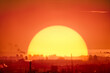 © Goinyk - Kyiv industrial cityscape sunset: sun round set at factories, buildings of european downtown. Red sunny sky of city scenery with dark background. Bright colorful graphic ukrainian town scape