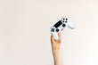 © Bostan Natalia - White video game joystick in hand on clean background.