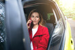 © Taras Grebinets - Portrait of a woman talking on cell phone sitting on a driver seat in her car