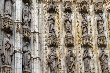 Poster - architectural detail of the door decorations and statues of the historic cathedral in Seville