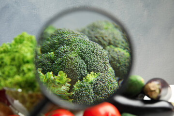 Wall Mural - view through magnifying glass on broccoli, closeup. poison detection