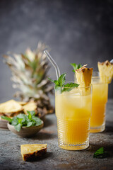 Fresh pineapple cocktail in the glass with ice and mint, summer drink