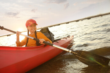 Poster - Happy girl kayaking on river. Summer camp activity