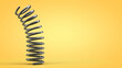 © Happyphotons - Dynamics of a metal spring. Yellow background. Copy space.