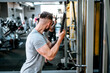 © aboutmomentsimages - Muscular man working out arms biceps at gym. Fitness life, healthy life concept
