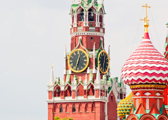 Spasskaya Tower of Moscow Kremlin and domes of the Cathedral of Vasily the Blessed (Saint Basil's Cathedral) on Red Square. Close-up. Moscow. Russia