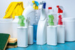 © Andrey - Cleaning and Disinfecting Your Home.large and small bottles and sprays with cleaning agents and cleaning tools