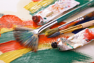 Brushes and paints for painting on an old background.