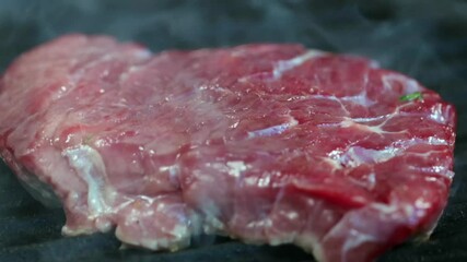 Sticker - raw beef steak grilled on a hot smoky grill pan