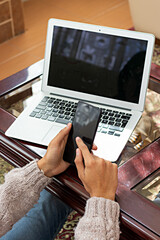 hands of a young man holding a smartphone