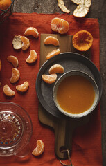 Wall Mural - Sliced tangerine with juice on a cutting board