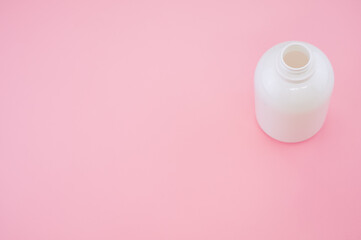 Poster - High angle shot of an empty bottle isolated on pink background