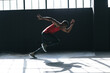 © Wavebreak Media - African american man wearing sports clothes sprinting in empty urban building