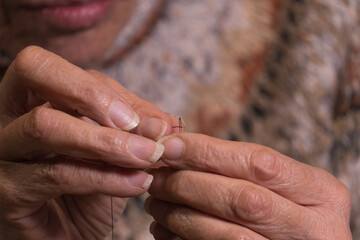 Canvas Print - Hands threading a needle