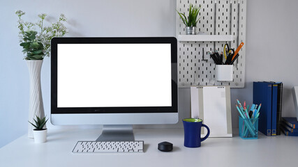 Wall Mural - front view of mock up computer with blank screen and office supplies on white table at stylish work 