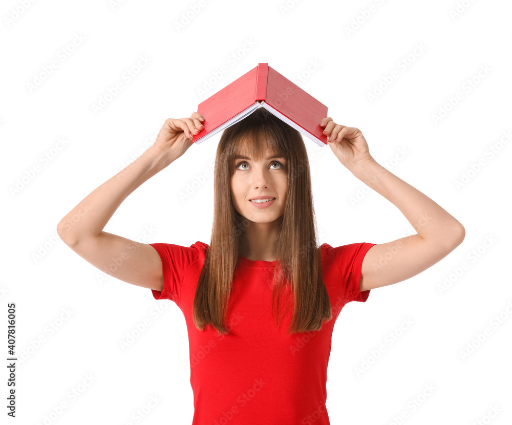 Beautiful young woman with book on white background