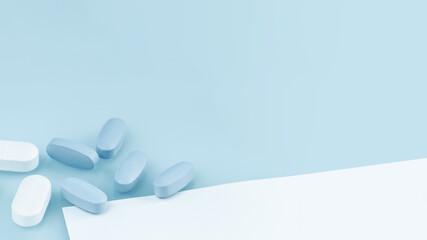 Wall Mural - Several white and blue tablets or pills on the table. Medicine and pharmacy