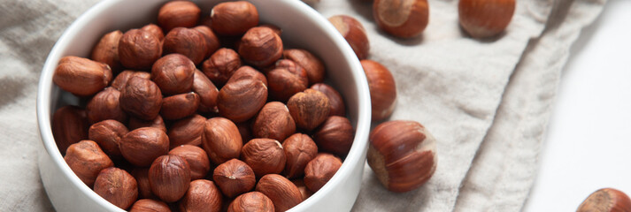 Wall Mural - Organic hazelnut in bowl on dark grey