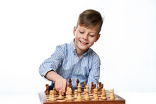 Cute Smiling Caucasian Boy Shows Chess Pieces On A Chessboard