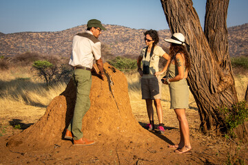 Wall Mural - Guide explains termite mound bloodstain to women