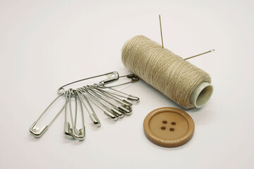 Sewing accessories. Threads, needles, tape measure, buttons, pins. Close-up. White background. Hobby. Needlework. Sewing