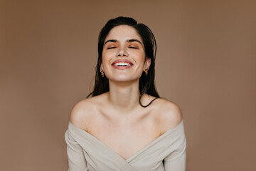 Poster - Debonair woman laughing in studio. Dreamy black-haired girl expressing happiness.