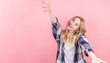 © Studio Nova - Happy cheerful young blonde woman rejoices at positive news or birthday present looking at the camera and holding out her hands to her with a joyful and charming smile
