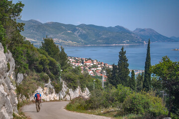 Sticker - Tourist walk along the road to a beautiful historic fortified Korcula town in Croatia