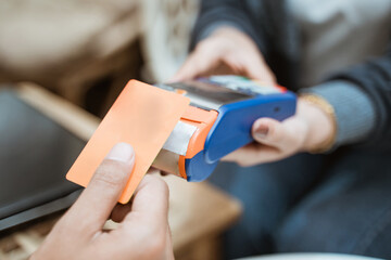 close up of credit card near the Electronic Data Capture machine when shopping at the store