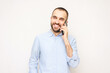 © Анастасия Семашко - Smiling young man talking on mobile phone, white background, copy space