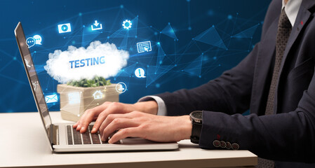 businessman working on laptop with testing inscription, modern technology concept
